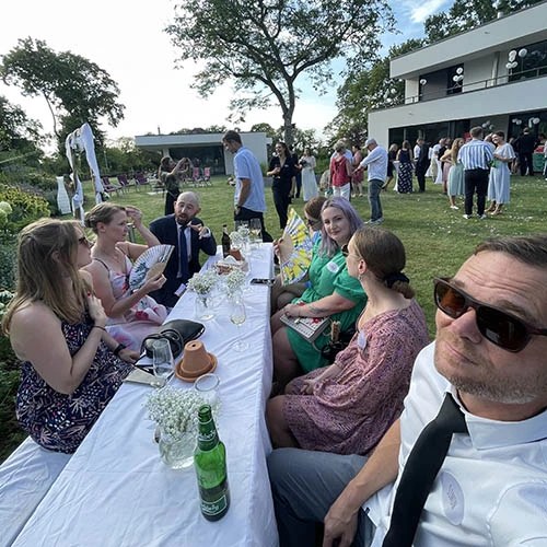 Wedding guests sharing candid photos around a reception table
